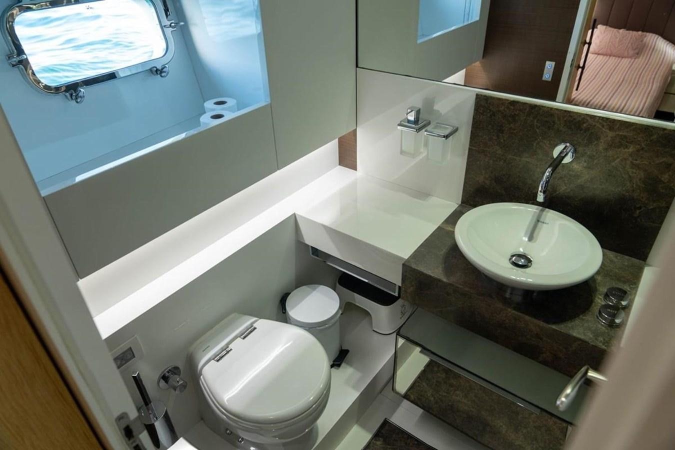 a bathroom with a sink and a toilet aboard ARCADIA 85 2015 Yacht for Sale