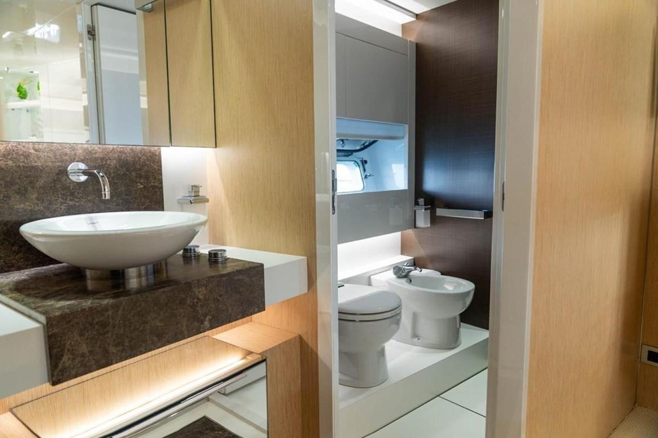 a bathroom with a sink and a toilet aboard ARCADIA 85 2015 Yacht for Sale