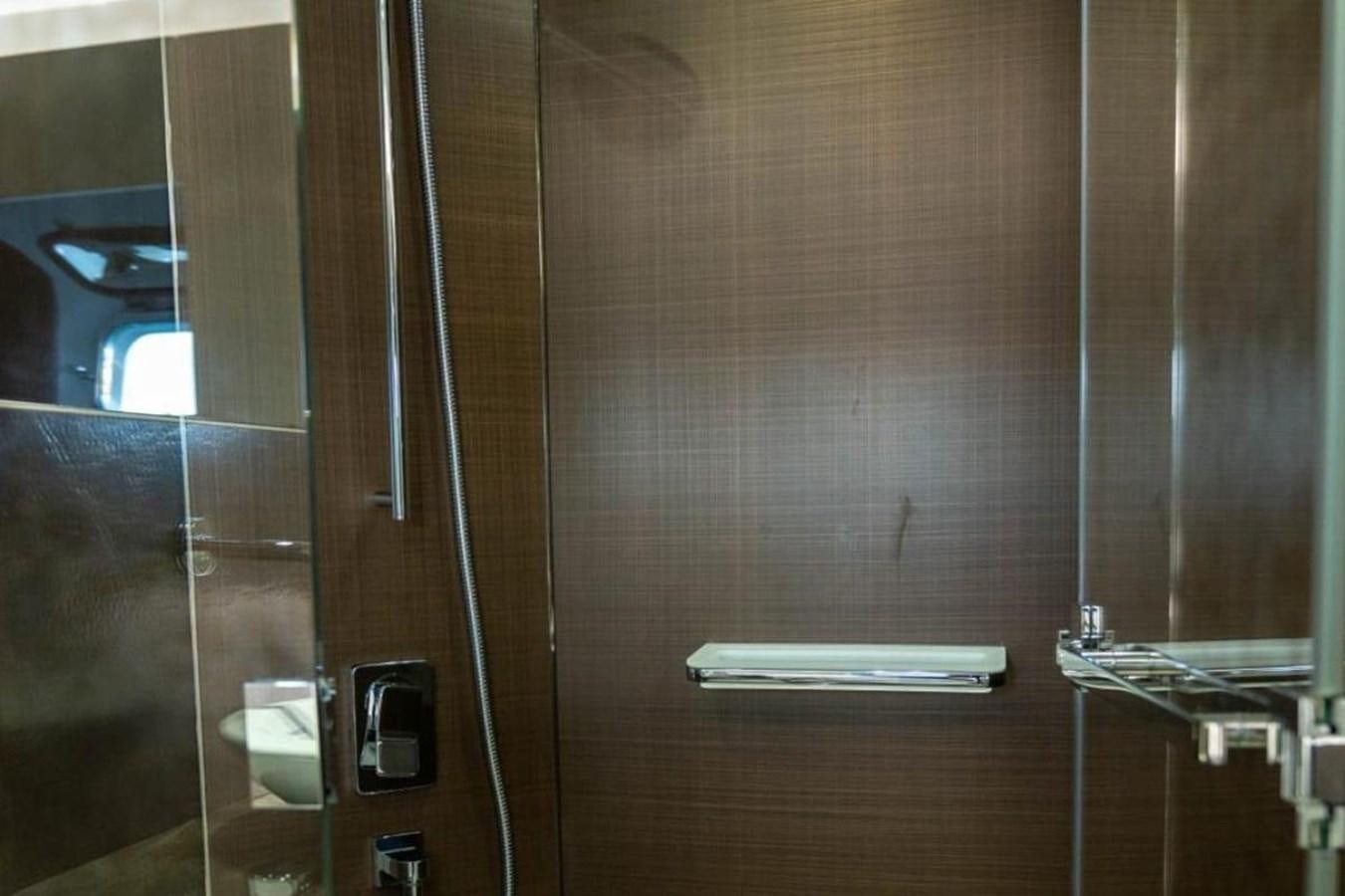 a bathroom with a glass shower aboard ARCADIA 85 2015 Yacht for Sale