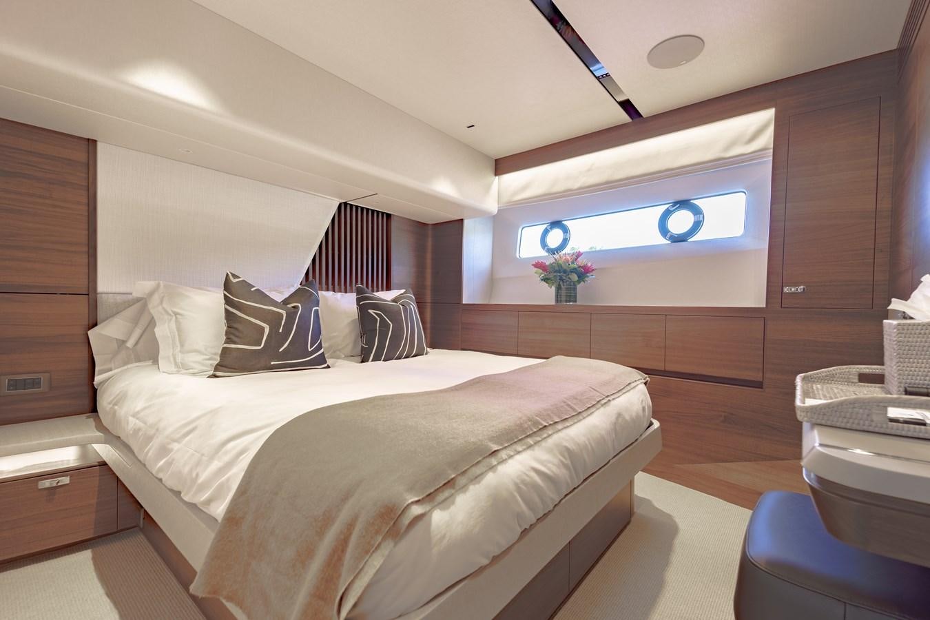 a bedroom with a bed and a desk aboard ESCAPEMENT Yacht for Sale