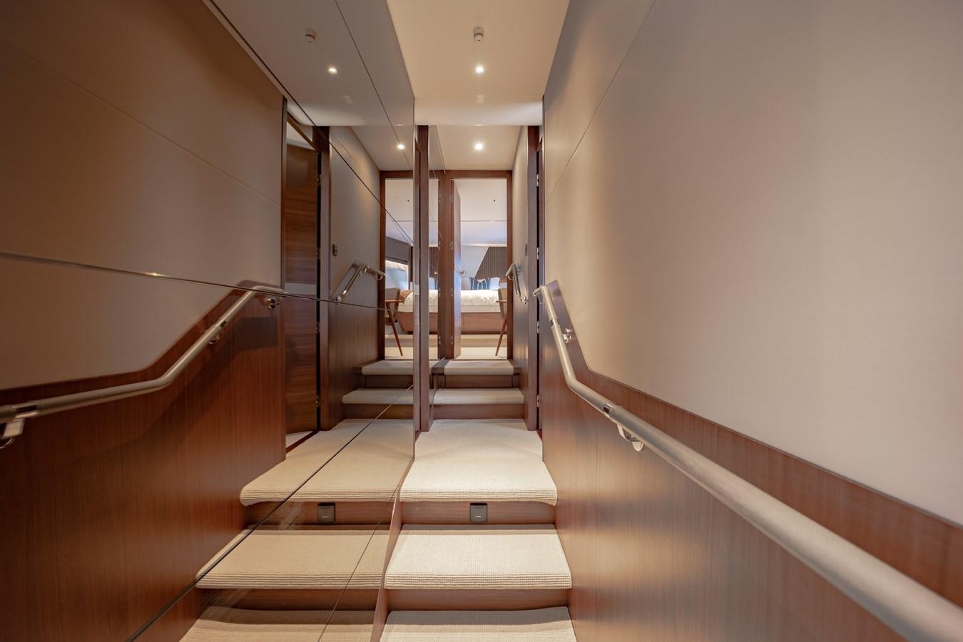 a hallway with a staircase aboard ESCAPEMENT Yacht for Sale