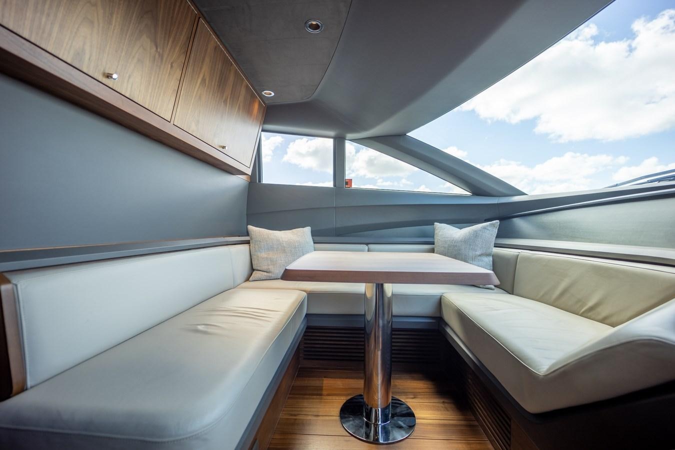 a boat with a table and a bench aboard ESCAPEMENT Yacht for Sale