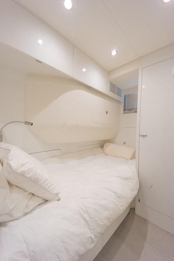 a room with white bedding aboard ESCAPEMENT Yacht for Sale