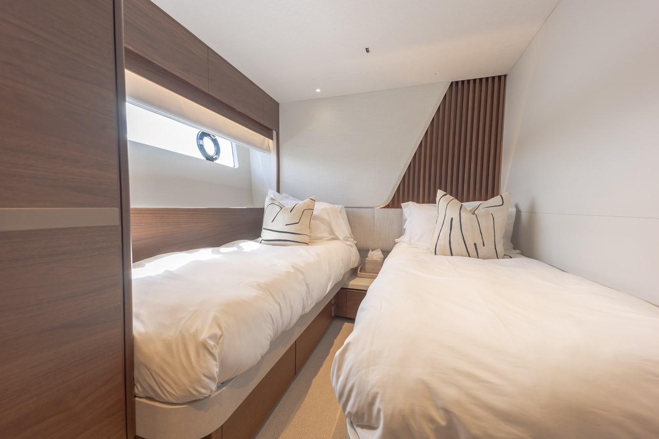 a room with two beds aboard ESCAPEMENT Yacht for Sale