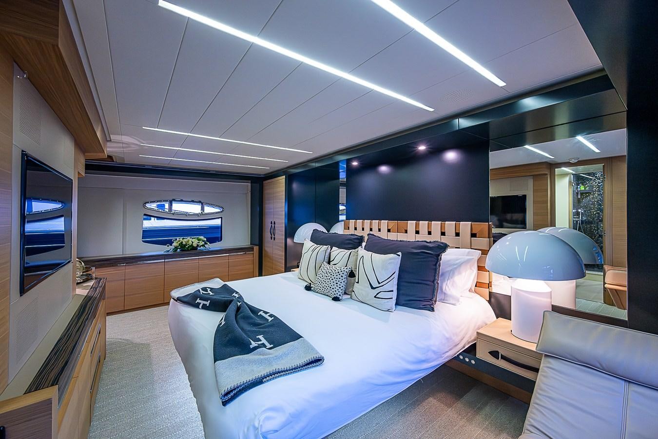 a modern bedroom with a large bed aboard COAL BLOODED Yacht for Sale