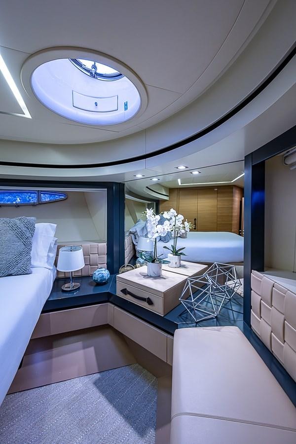 a room with a bed and a table with flowers aboard COAL BLOODED Yacht for Sale