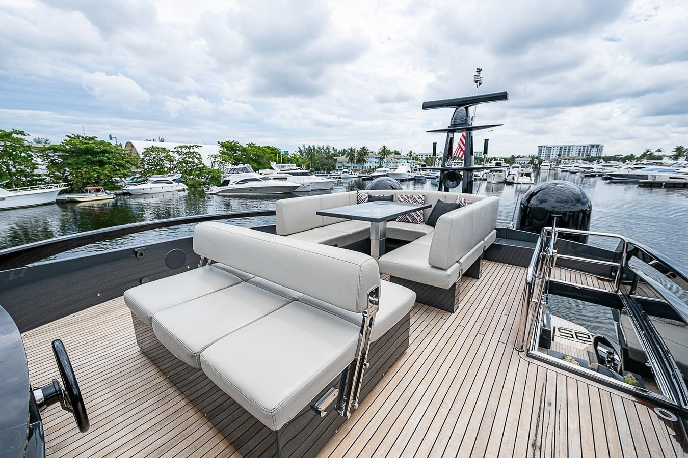 a deck with a table and chairs on it aboard COAL BLOODED Yacht for Sale