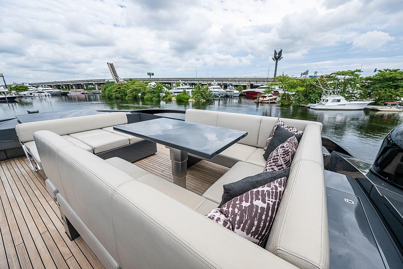 a deck with a table and chairs on it aboard COAL BLOODED Yacht for Sale