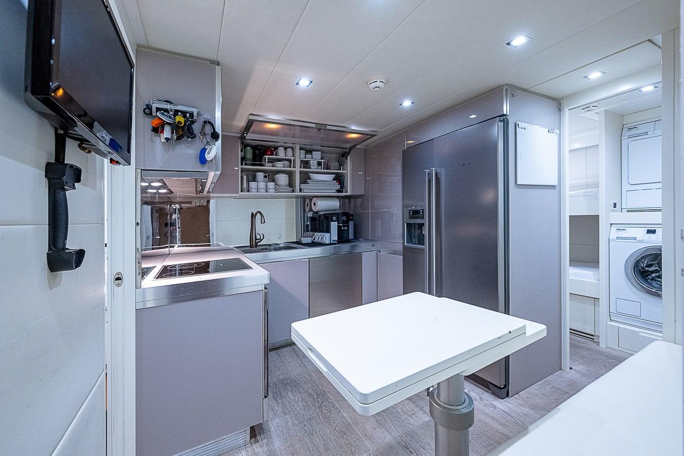 a large kitchen with a large refrigerator aboard COAL BLOODED Yacht for Sale