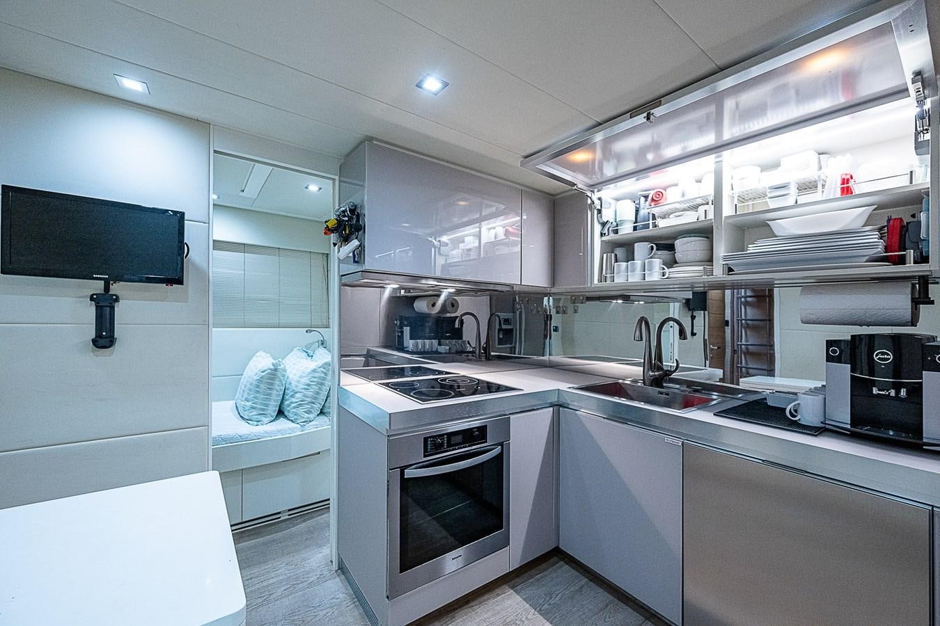 a kitchen with white cabinets aboard COAL BLOODED Yacht for Sale