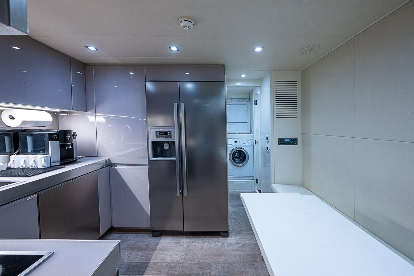 a kitchen with a refrigerator and a microwave aboard COAL BLOODED Yacht for Sale