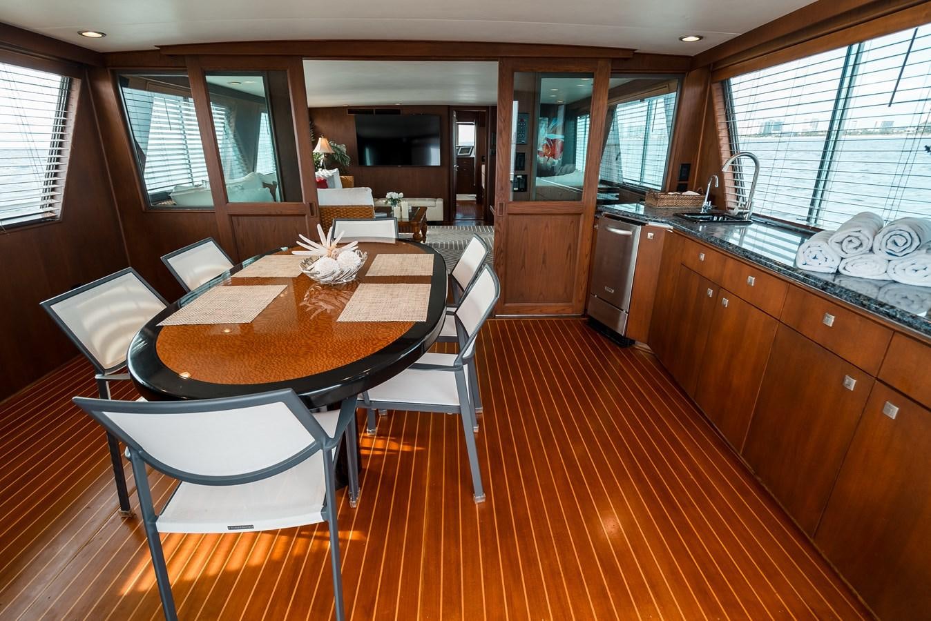 a kitchen with a table and chairs aboard HIGH IMPACT Yacht for Sale