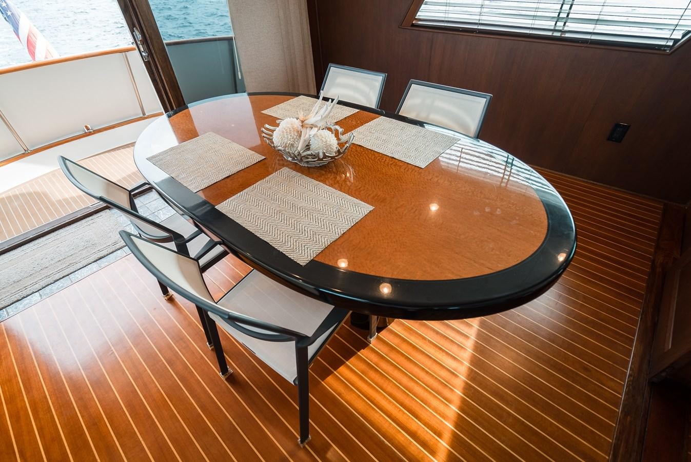 a table with chairs around it aboard HIGH IMPACT Yacht for Sale