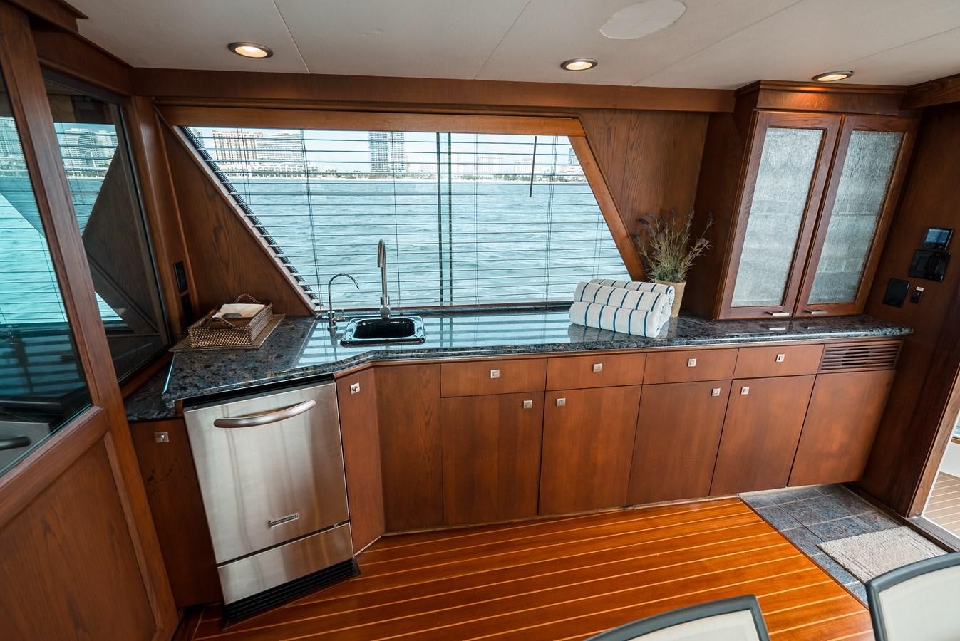 a kitchen with wooden cabinets aboard HIGH IMPACT Yacht for Sale