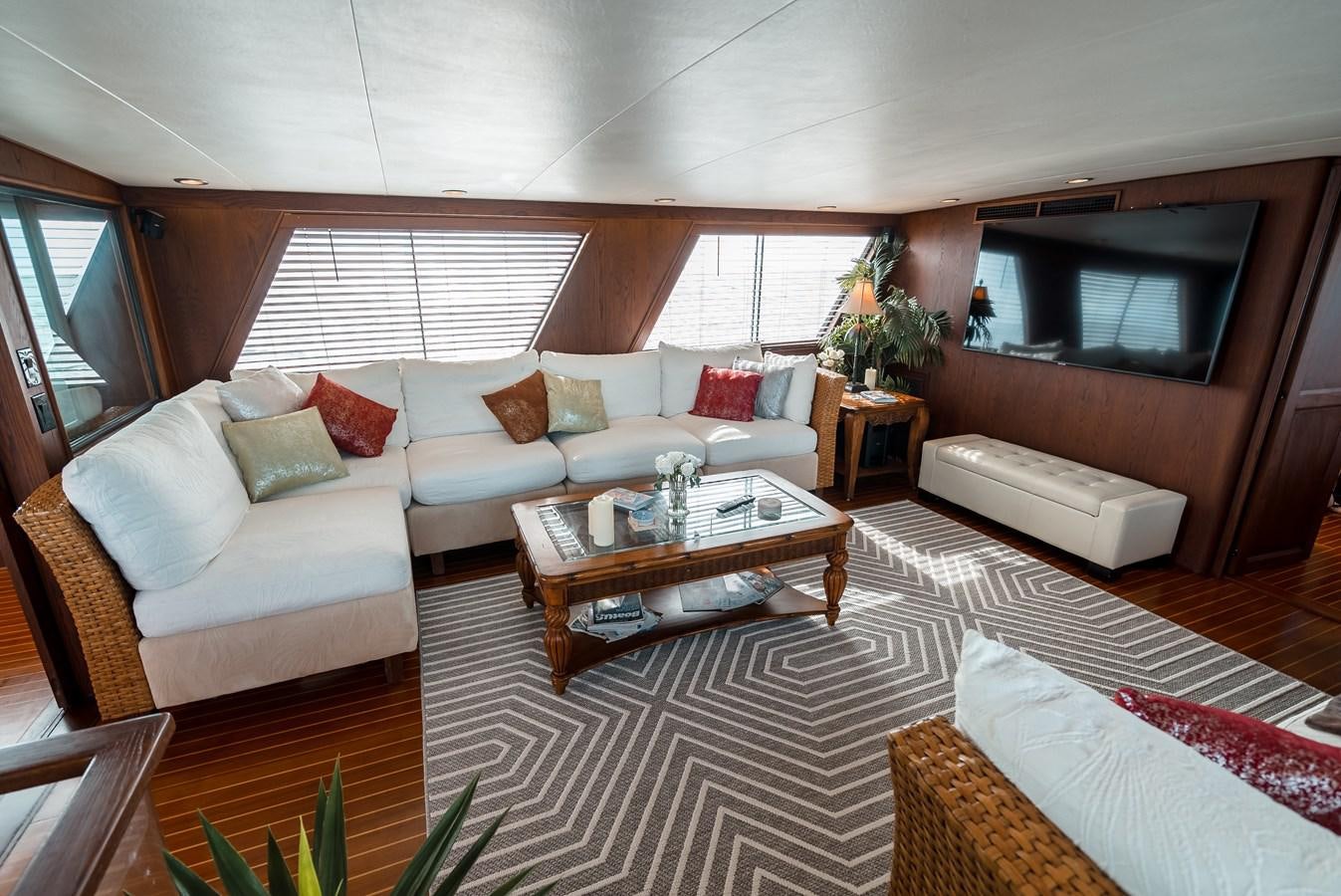 a living room with a couch and a coffee table aboard HIGH IMPACT Yacht for Sale