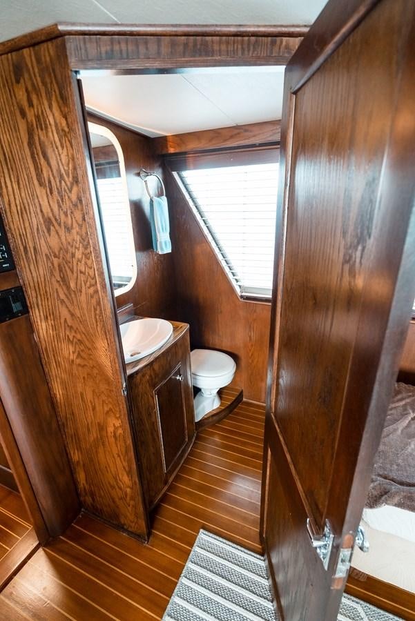 a bathroom with a wood door aboard HIGH IMPACT Yacht for Sale