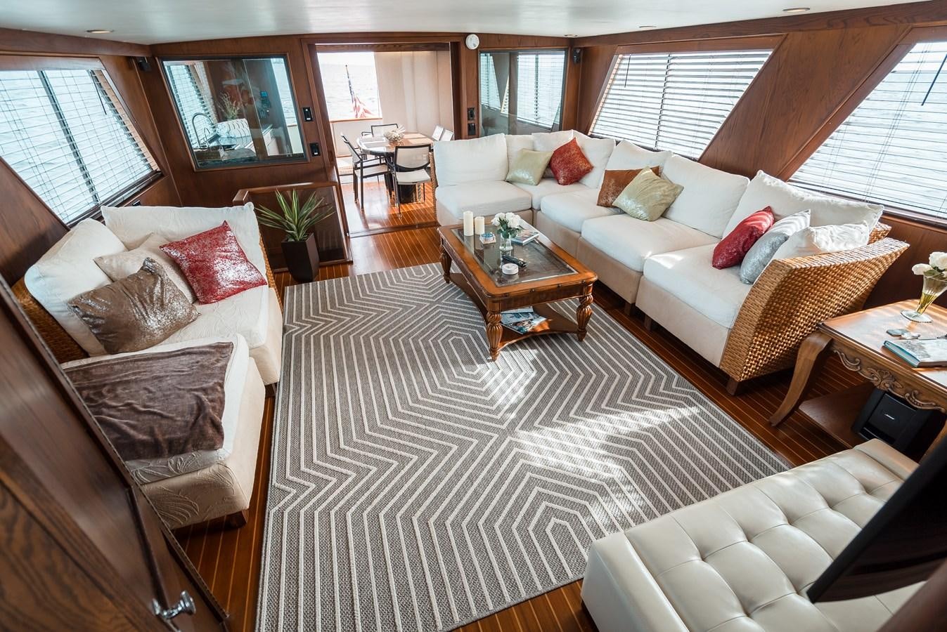 a living room with a couch and a coffee table aboard HIGH IMPACT Yacht for Sale