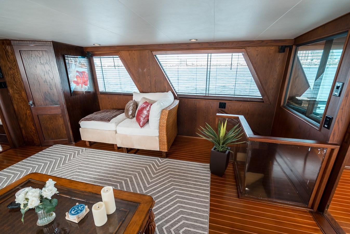a room with a bed and a table aboard HIGH IMPACT Yacht for Sale