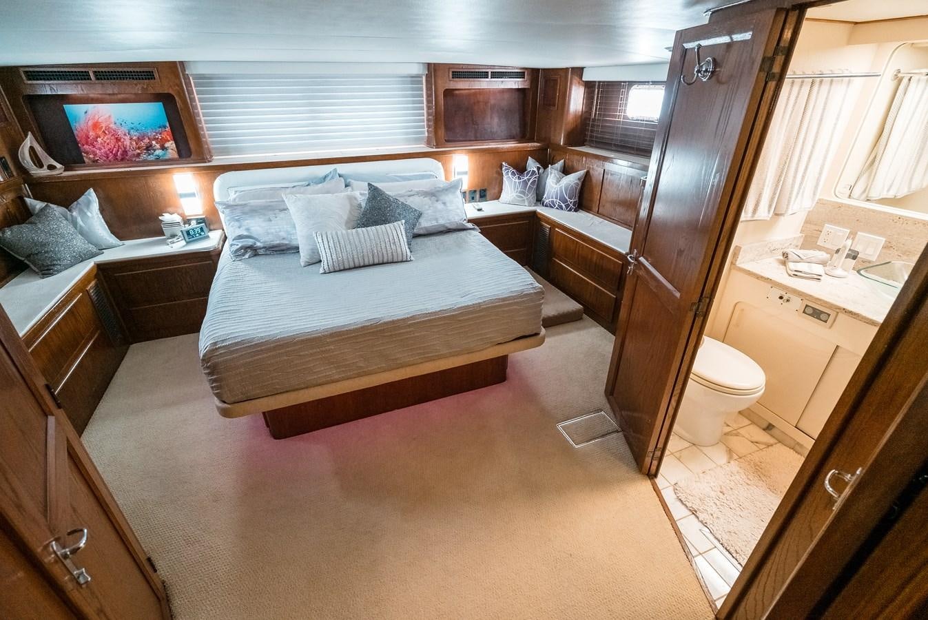 a bedroom with a bed and a sink aboard HIGH IMPACT Yacht for Sale