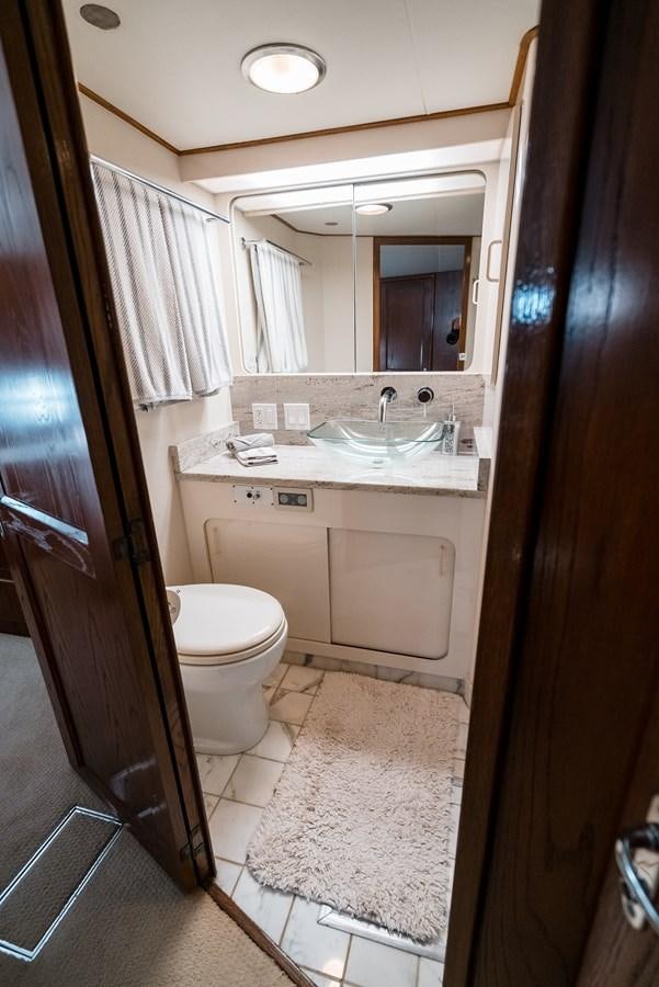 a bathroom with a sink and a toilet aboard HIGH IMPACT Yacht for Sale