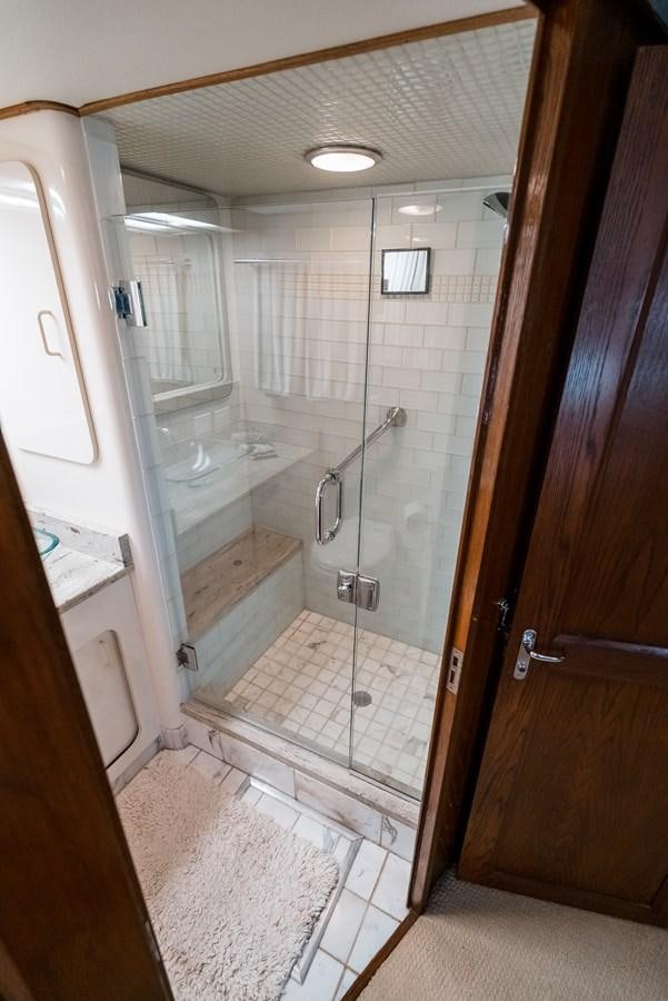 a bathroom with a glass shower aboard HIGH IMPACT Yacht for Sale