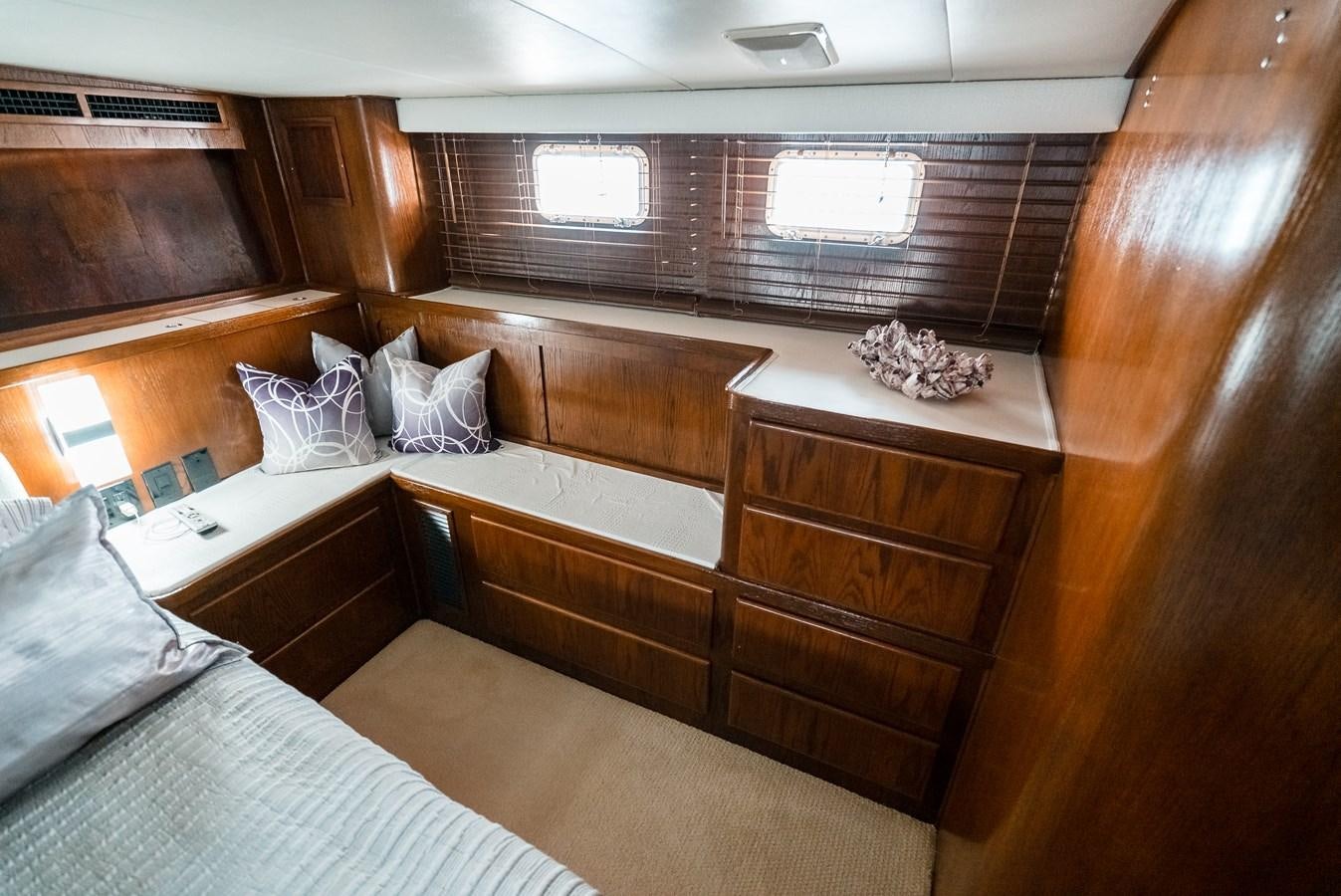 a room with wooden furniture aboard HIGH IMPACT Yacht for Sale