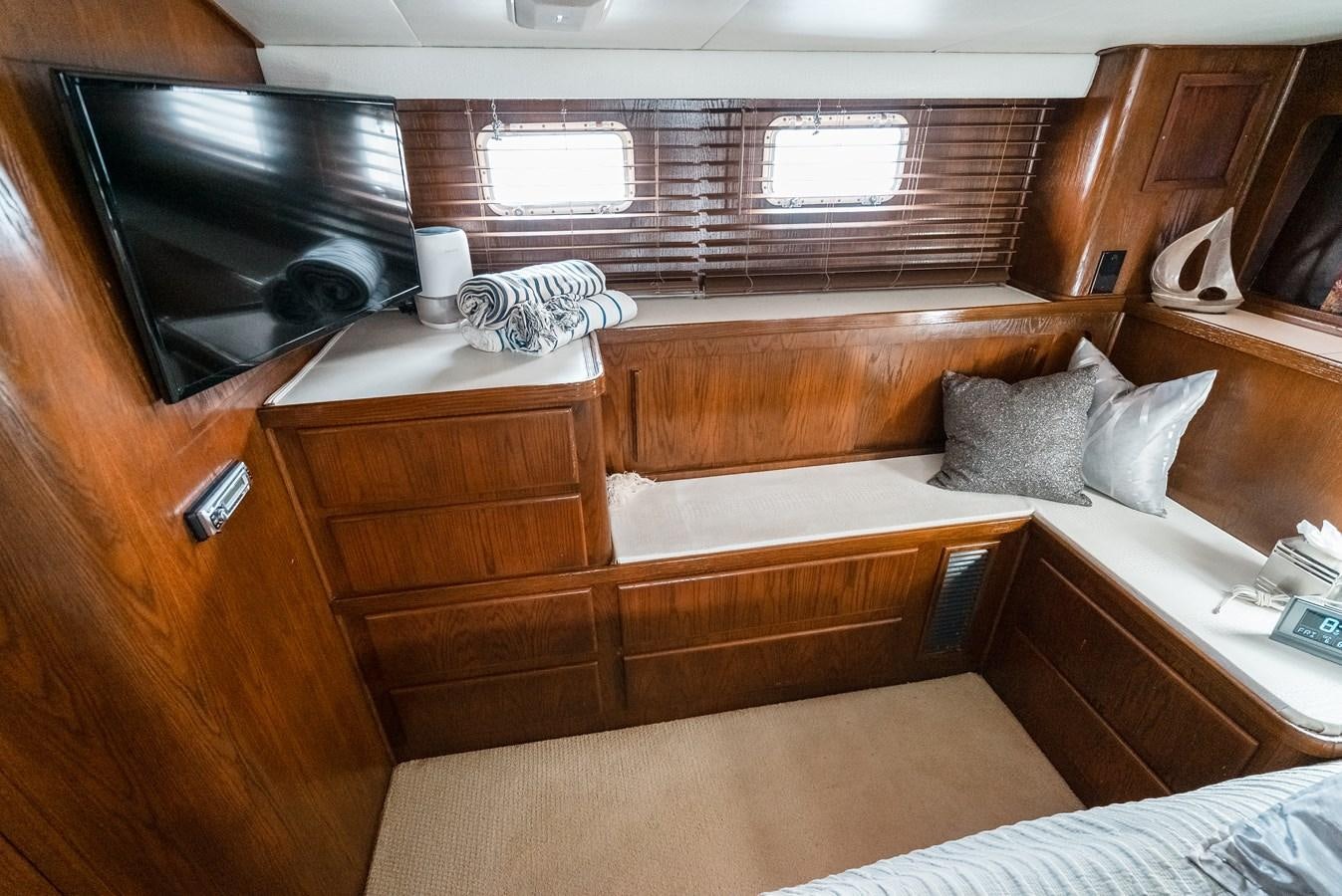 a room with a bed and a television aboard HIGH IMPACT Yacht for Sale