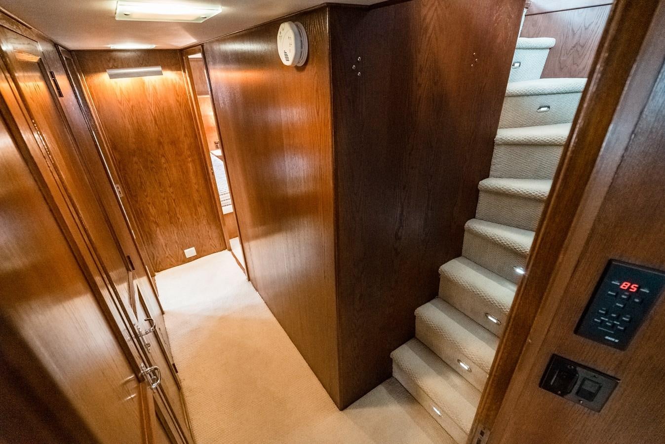 a wooden staircase with a sign aboard HIGH IMPACT Yacht for Sale