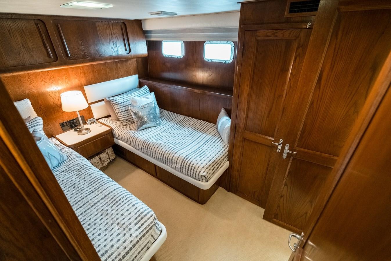 a room with a bed and a desk aboard HIGH IMPACT Yacht for Sale