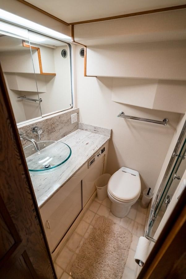 a bathroom with a sink toilet and a bathtub aboard HIGH IMPACT Yacht for Sale