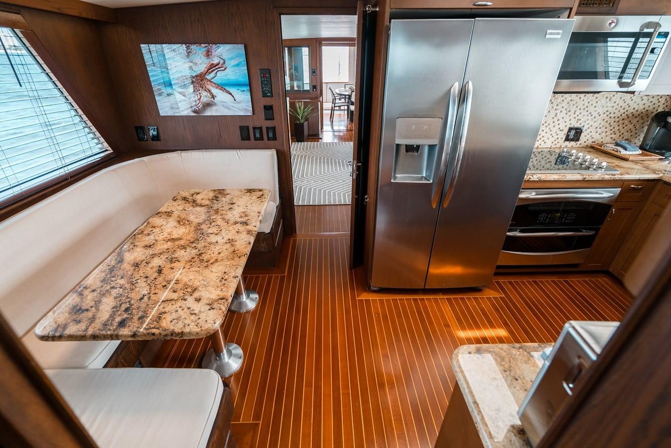 a kitchen with a large refrigerator aboard HIGH IMPACT Yacht for Sale