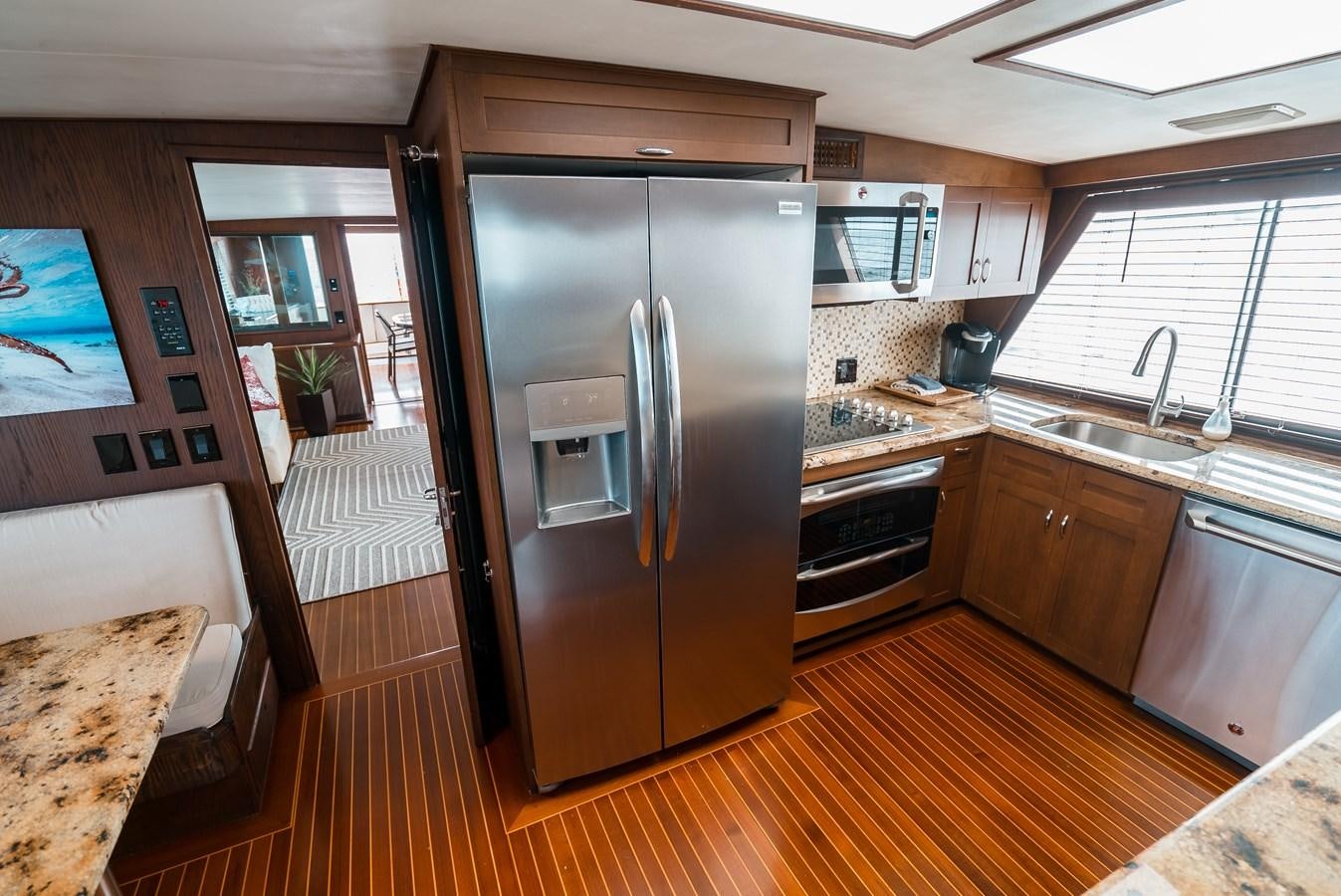 a kitchen with a stainless steel refrigerator aboard HIGH IMPACT Yacht for Sale