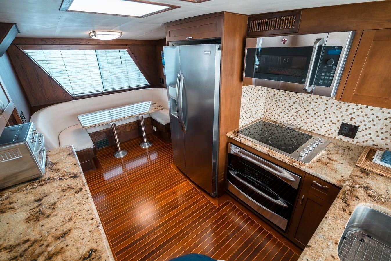 a kitchen with a large refrigerator aboard HIGH IMPACT Yacht for Sale