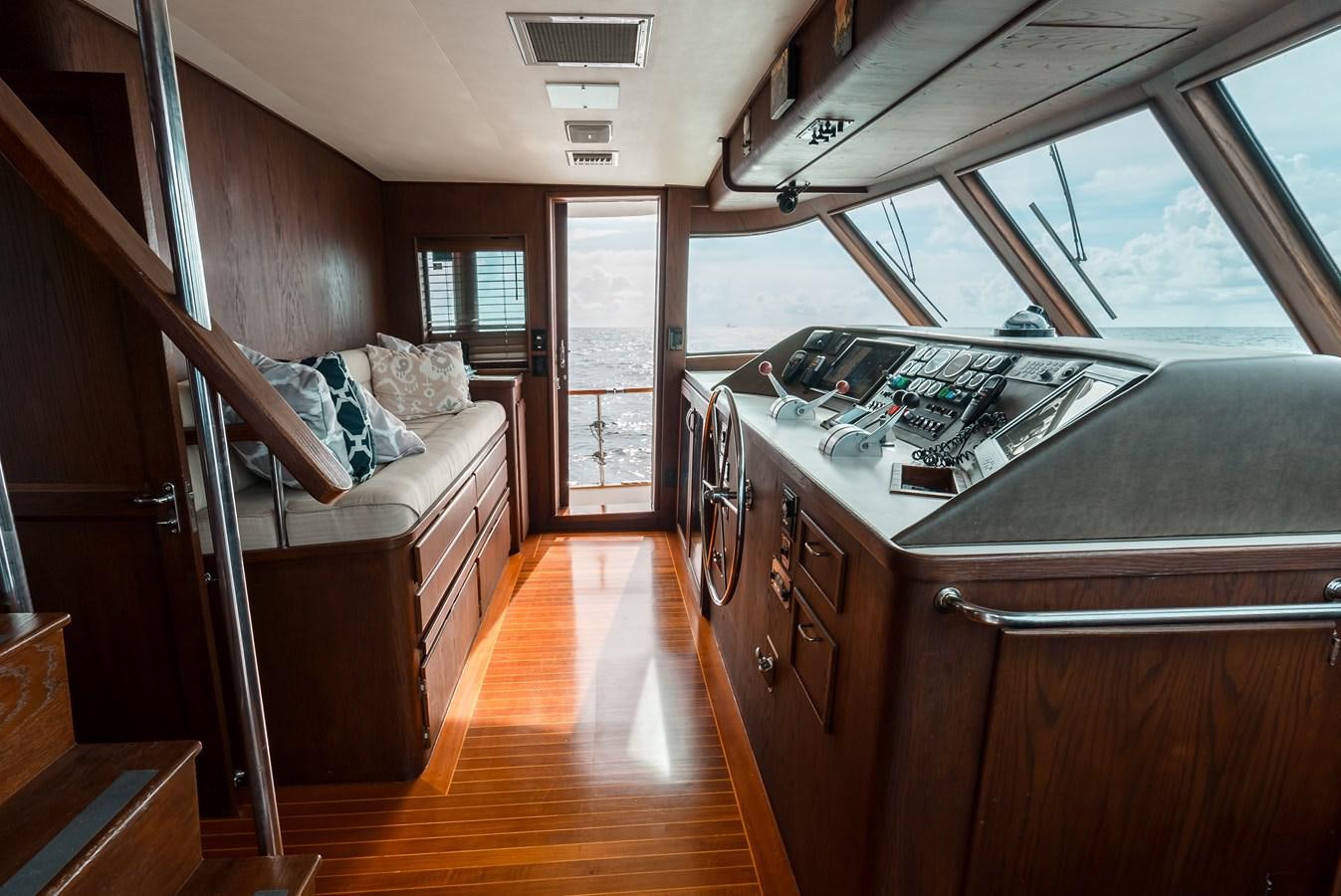 a kitchen with a large wood staircase aboard HIGH IMPACT Yacht for Sale