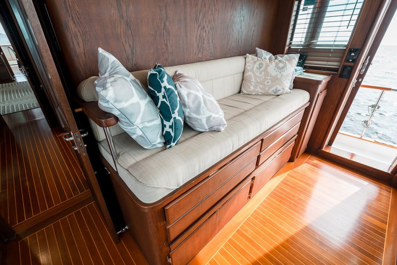a couch with pillows on it aboard HIGH IMPACT Yacht for Sale
