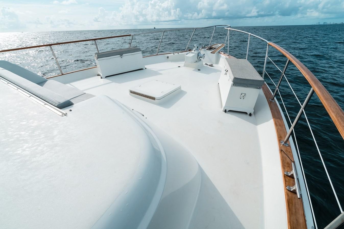 a large white boat with a large metal ladder on the side aboard HIGH IMPACT Yacht for Sale