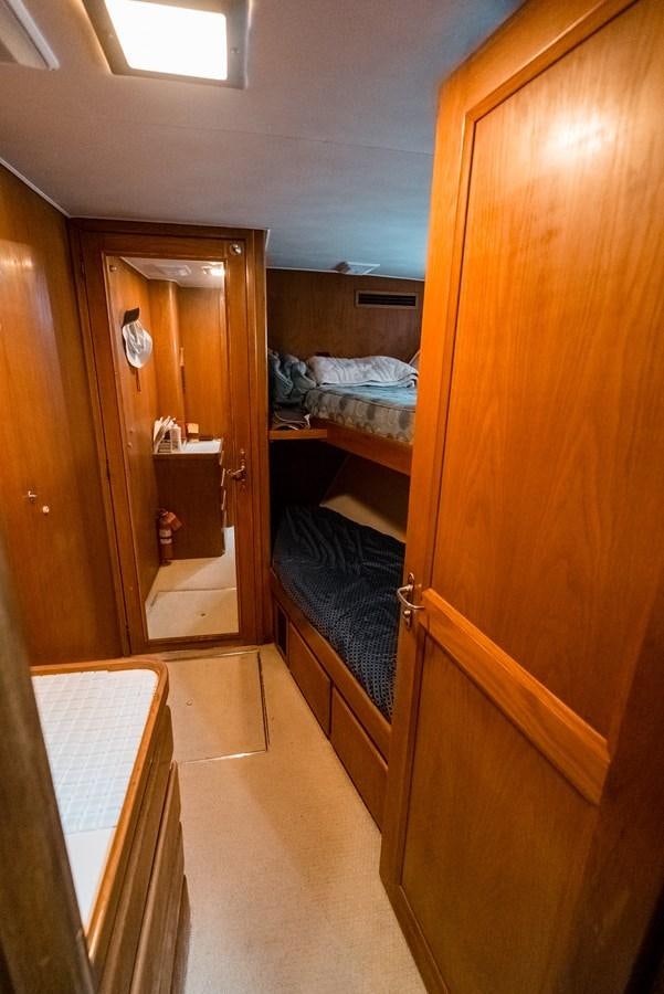 a room with a bed and a closet aboard HIGH IMPACT Yacht for Sale
