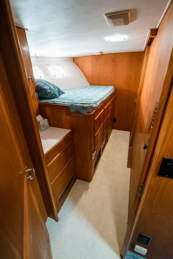 a bedroom with a bed and a closet aboard HIGH IMPACT Yacht for Sale