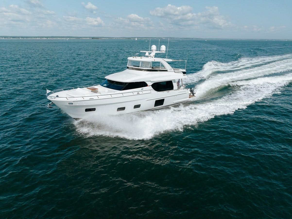 a white yacht on the water aboard THE THREE B'S Yacht for Sale