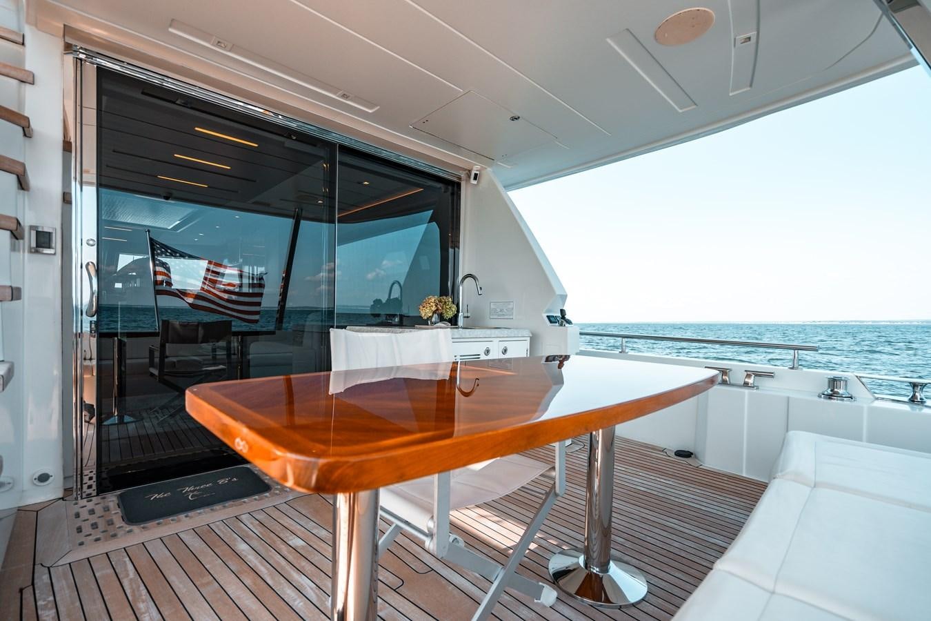 a table with a bench on it aboard THE THREE B'S Yacht for Sale