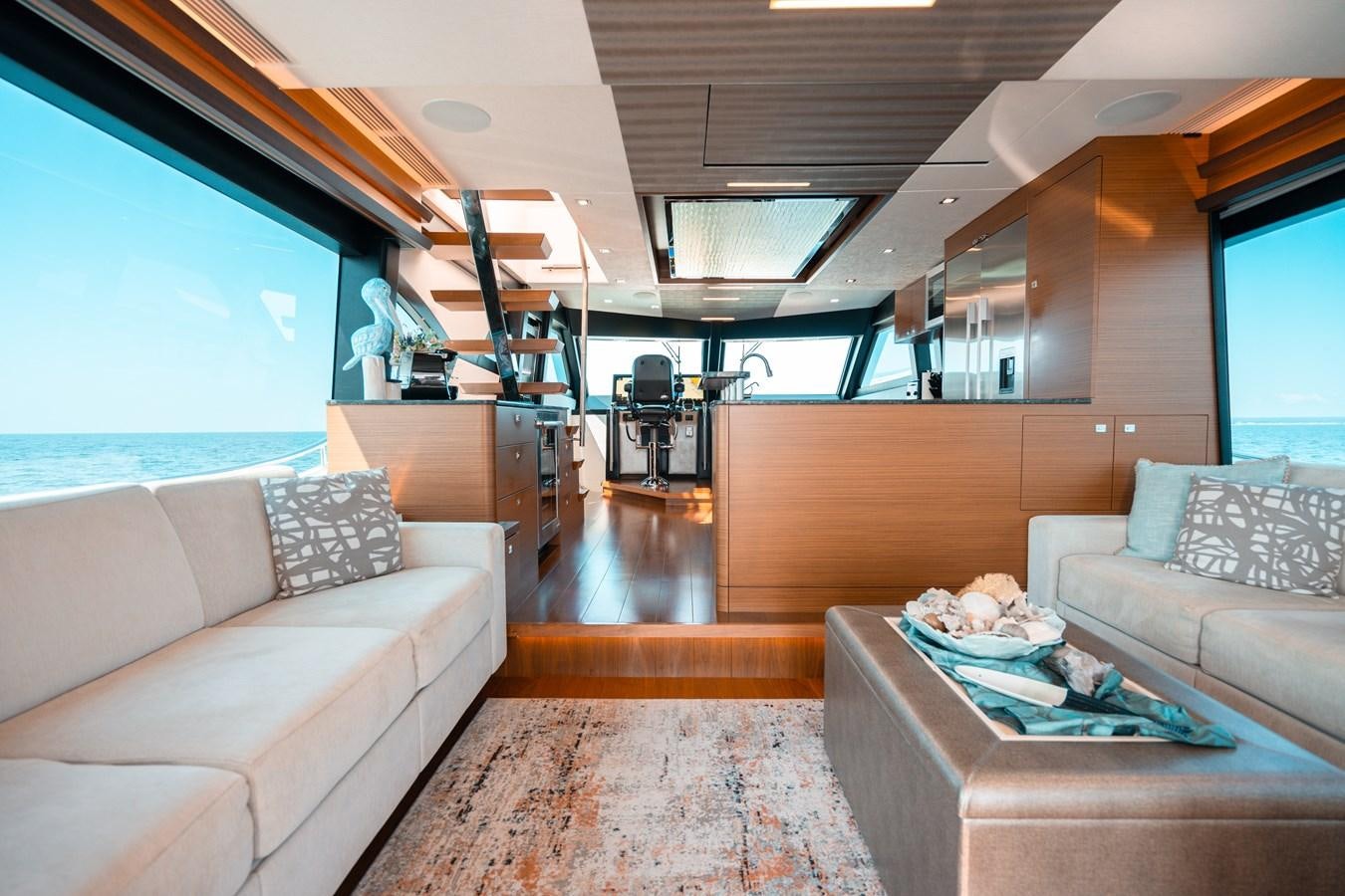 a room with a couch and a table and a ladder aboard THE THREE B'S Yacht for Sale