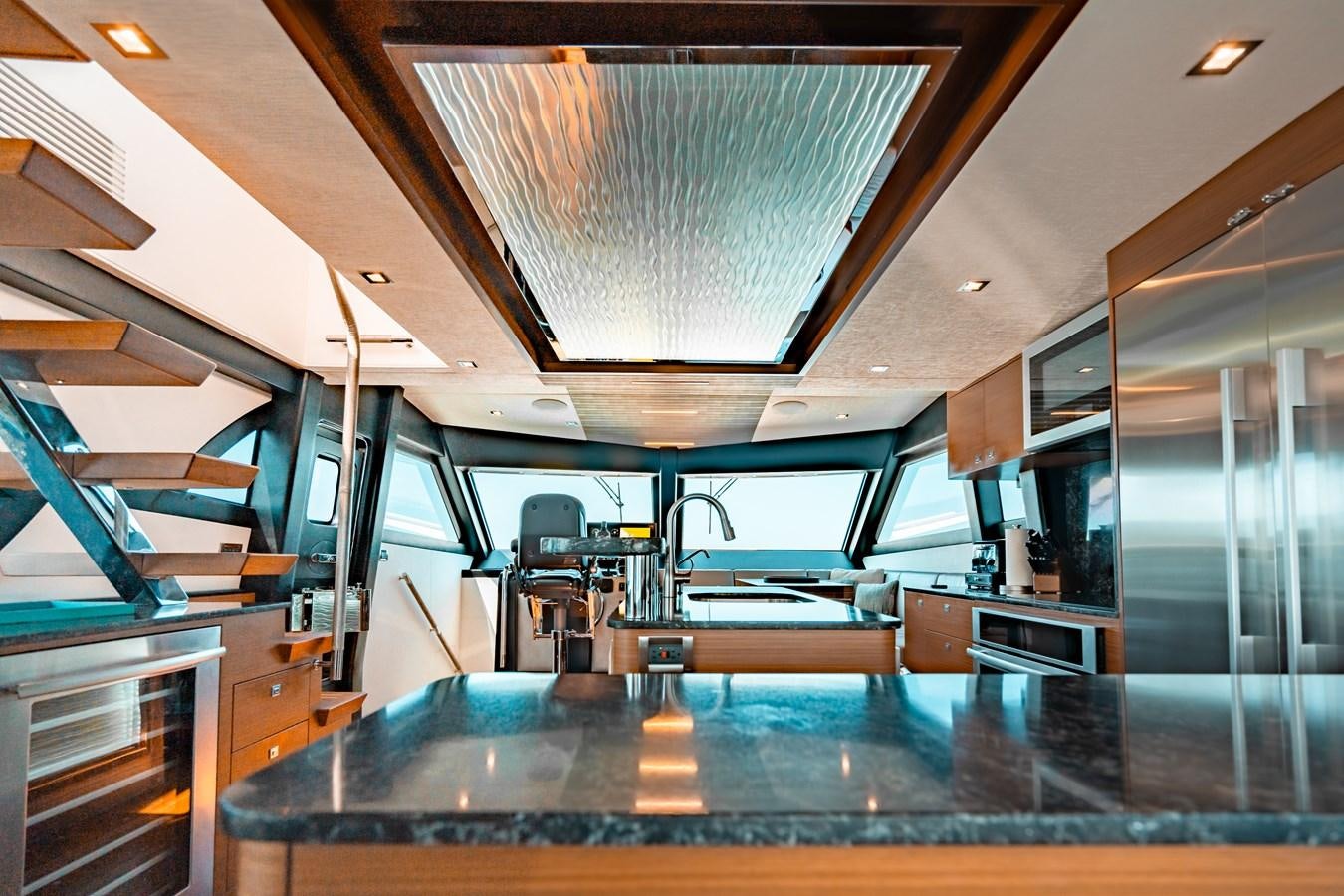a room with a table and chairs aboard THE THREE B'S Yacht for Sale