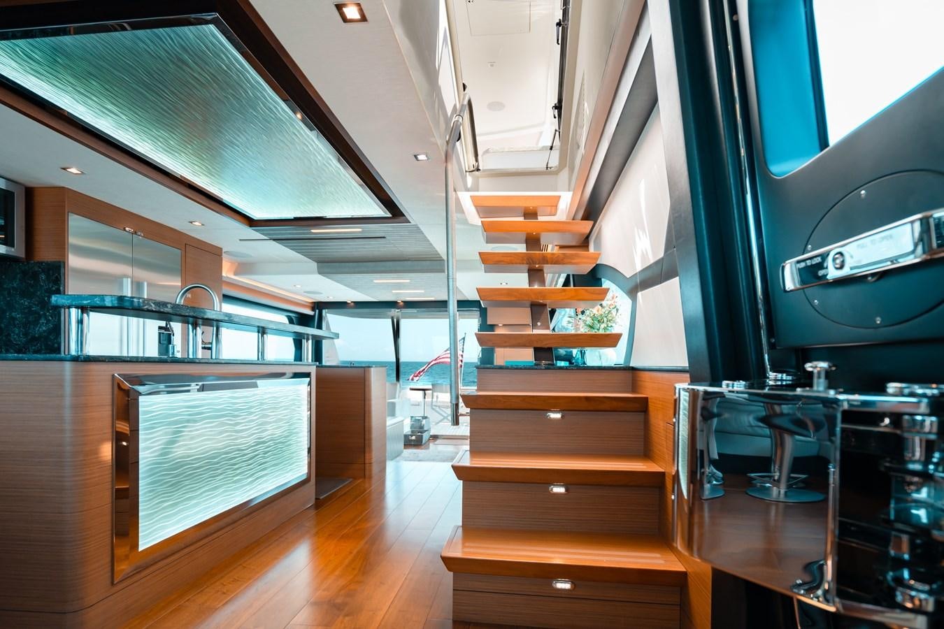 a wooden staircase with a glass railing aboard THE THREE B'S Yacht for Sale