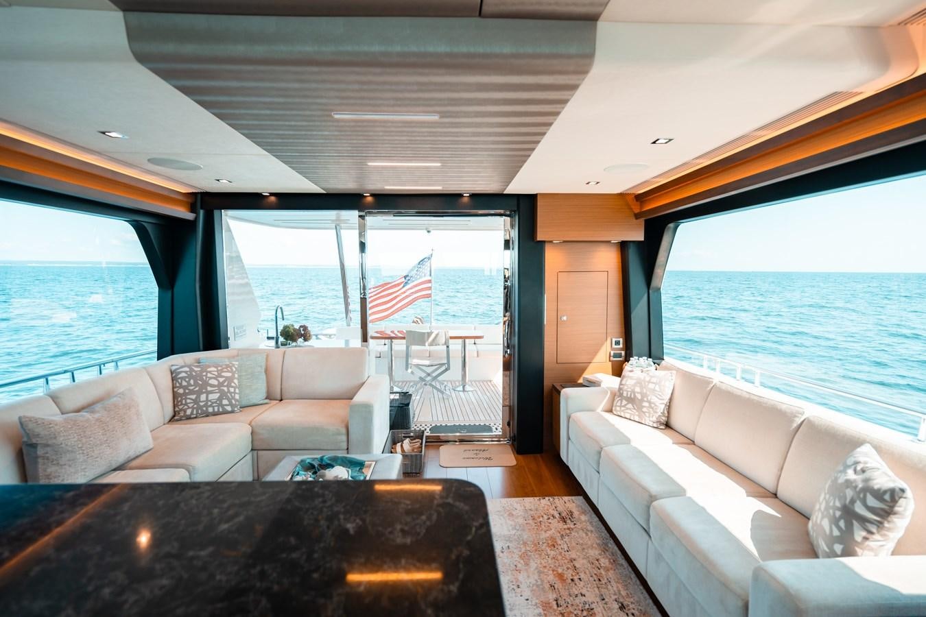 a living room with a large window aboard THE THREE B'S Yacht for Sale