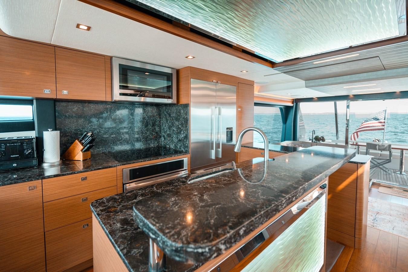 a kitchen with a large island aboard THE THREE B'S Yacht for Sale