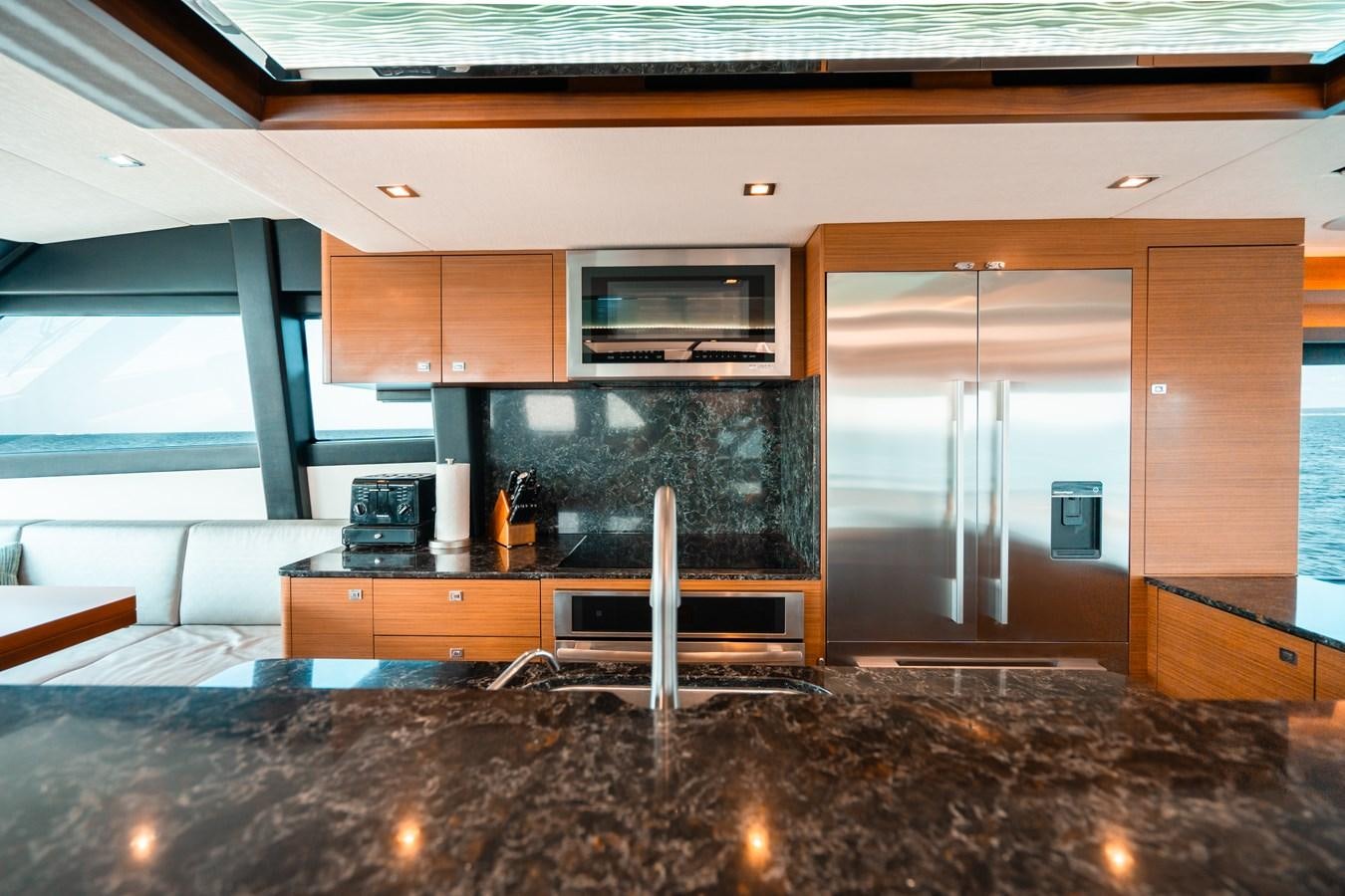 a large kitchen with a fireplace aboard THE THREE B'S Yacht for Sale