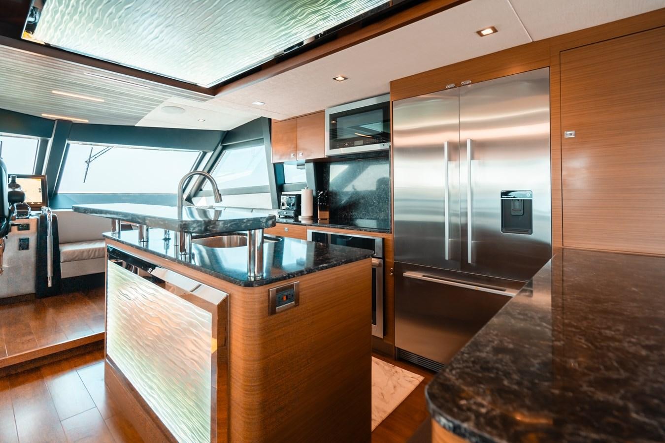 a kitchen with a stainless steel refrigerator aboard THE THREE B'S Yacht for Sale