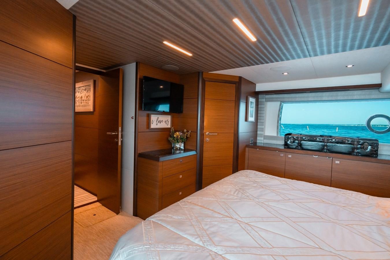 a bedroom with a bed and tv aboard THE THREE B'S Yacht for Sale