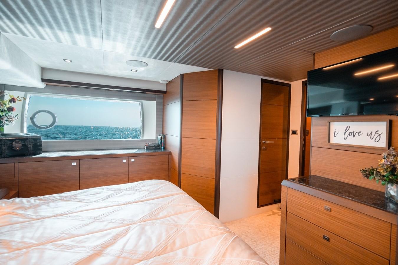 a bedroom with a bed and a desk aboard THE THREE B'S Yacht for Sale