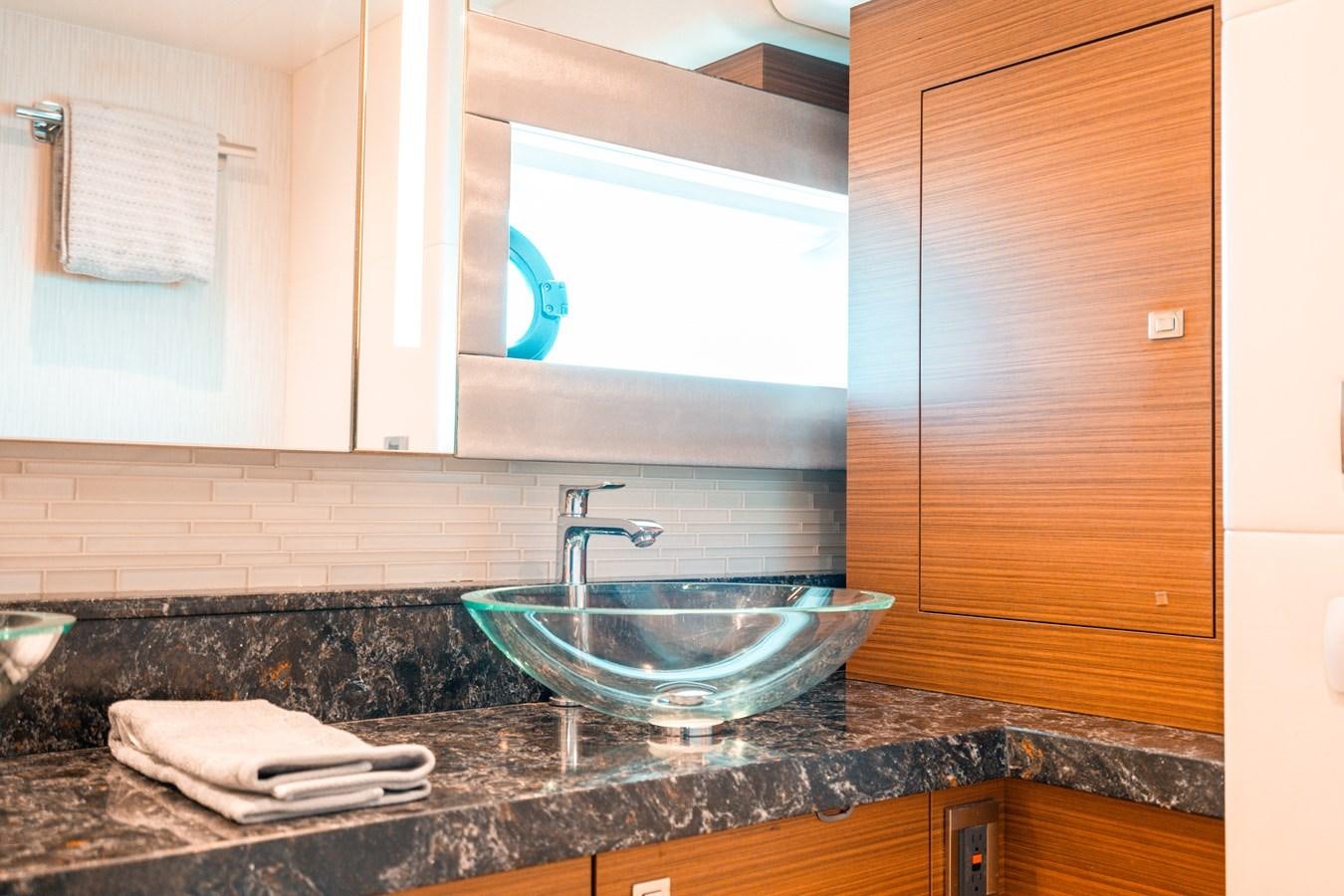 a bathroom with a sink and a mirror aboard THE THREE B'S Yacht for Sale